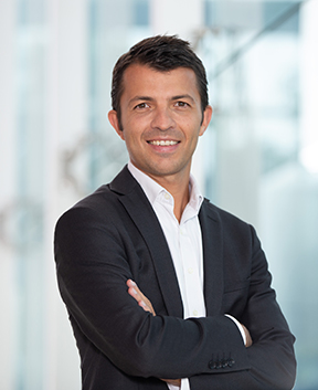 Portrait of professional in suit with arms folded