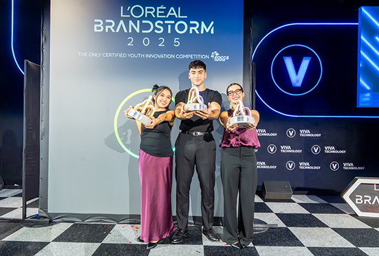 Three winners holding trophies at Brandstorm