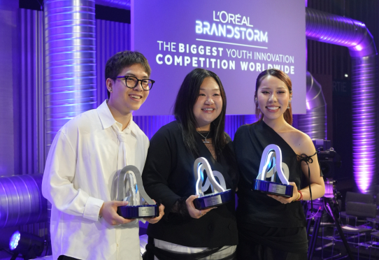 Three winners holding trophies at Brandstorm