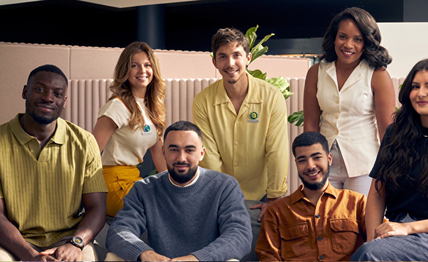 Six coworkers posing together indoors scene nicely