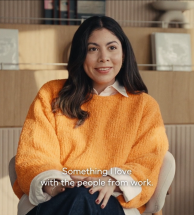 Person seated in chair speaking in interview setting