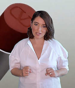 Person speaking with oversized lipstick backdrop.