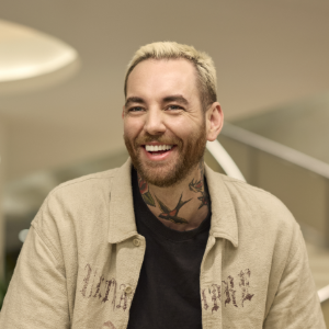 Man smiling indoors in casual setting