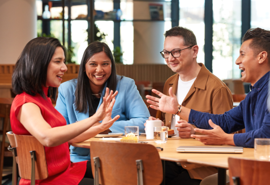 Group of colleagues chatting at a table