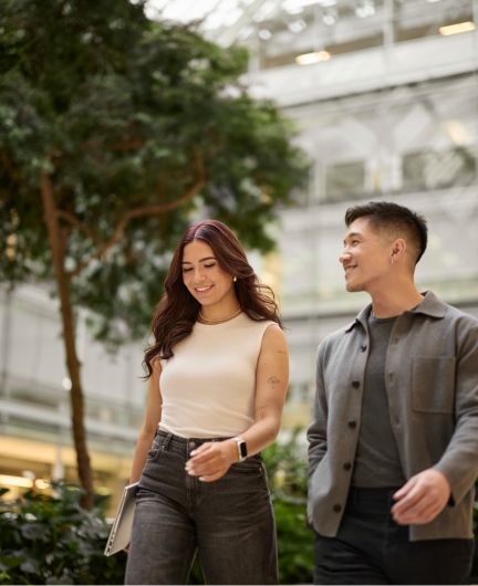 Two people walking and talking outdoors