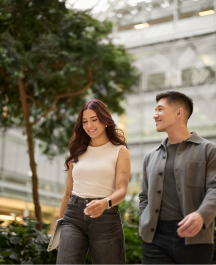 Two people walking and talking outdoors