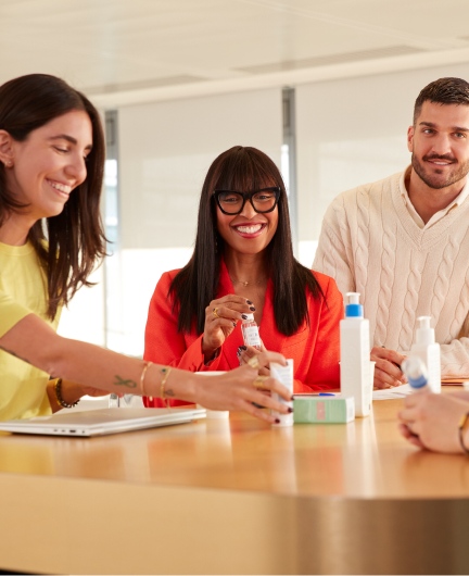 Three colleagues discussing products at table