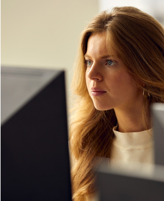 Person focused while working at a computer