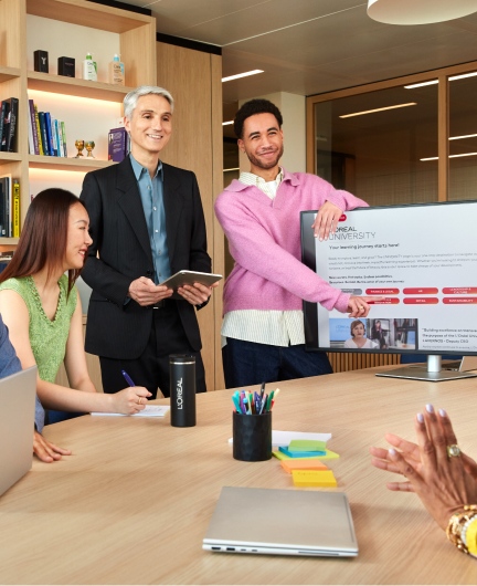 Person presenting screen to colleague at desk
