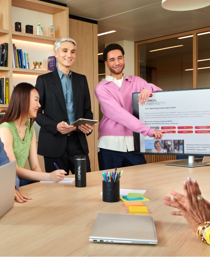 Person presenting screen to colleague at desk