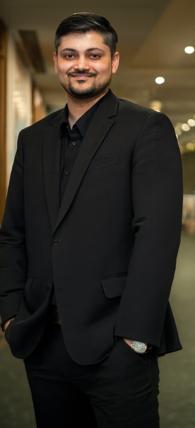 Professional portrait of man wearing black suit