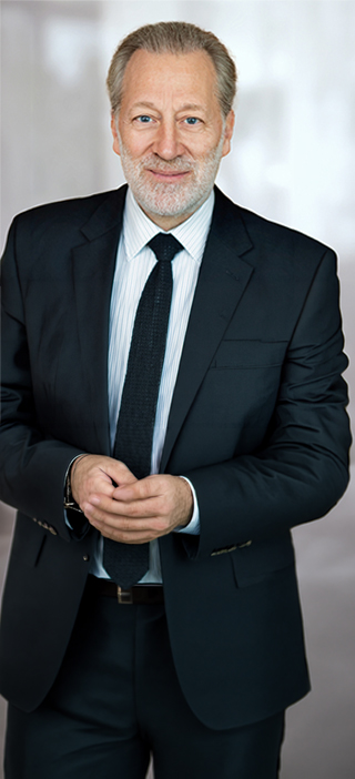 Older professional in suit looking at camera