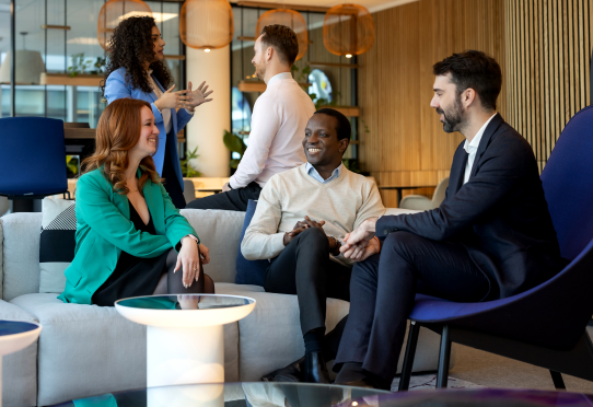 Group of colleagues talking in modern office lounge
