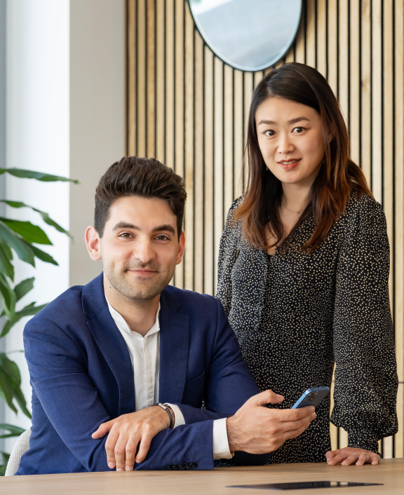 Two colleagues working at table in office