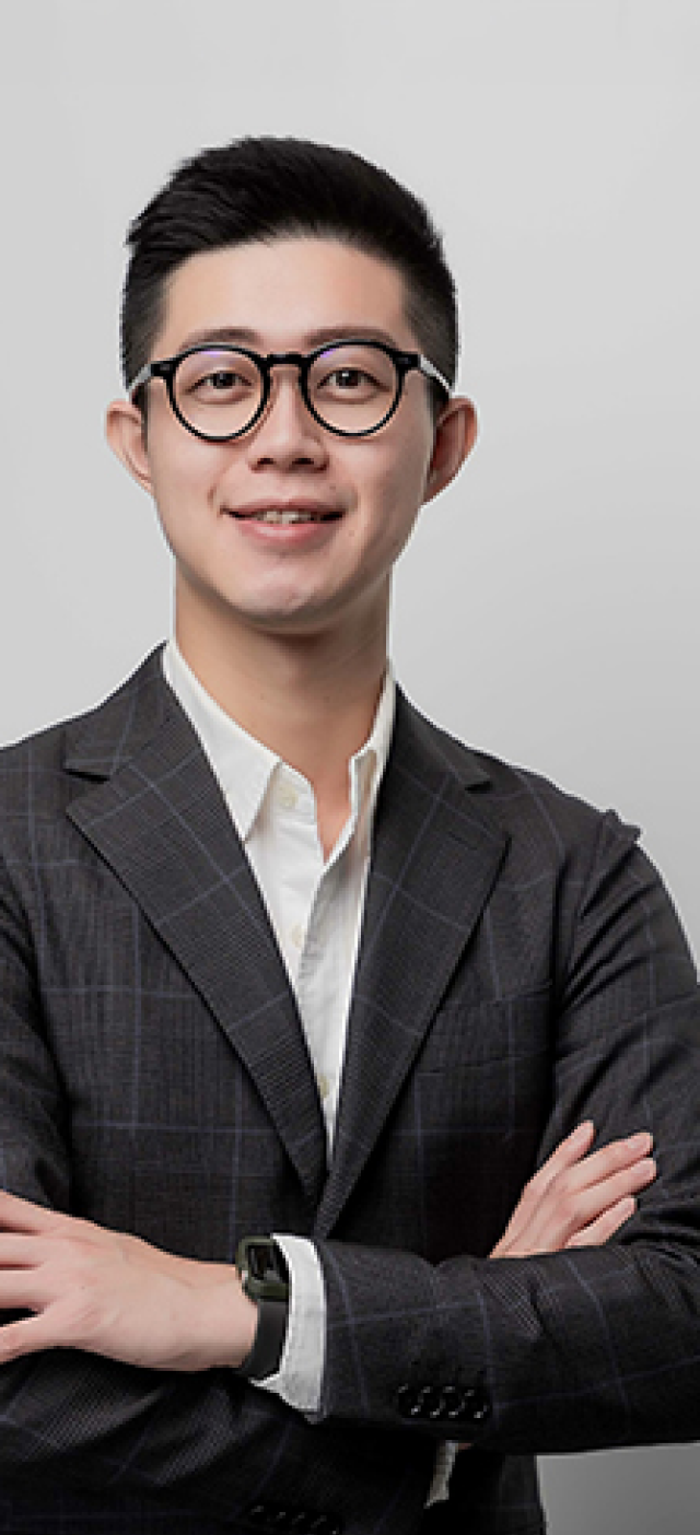 Confident professional standing with arms crossed