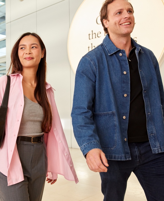Two people walking through a modern office