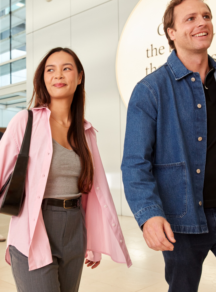 Two people walking through a modern office