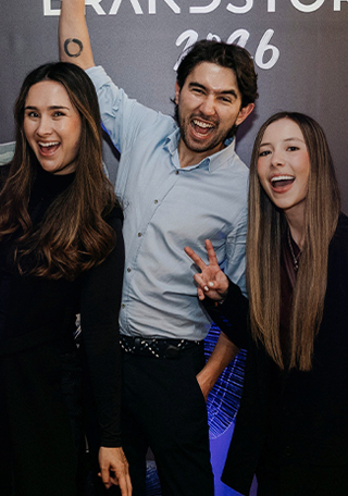 Group posing and celebrating together indoors