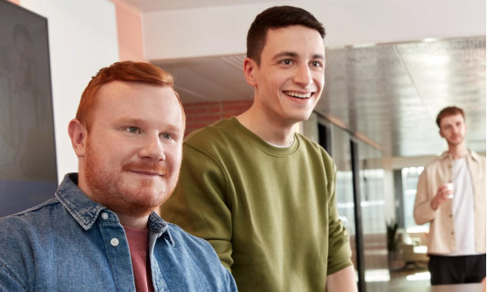 Two people standing and talking indoors