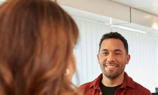 Person speaking to colleague in office