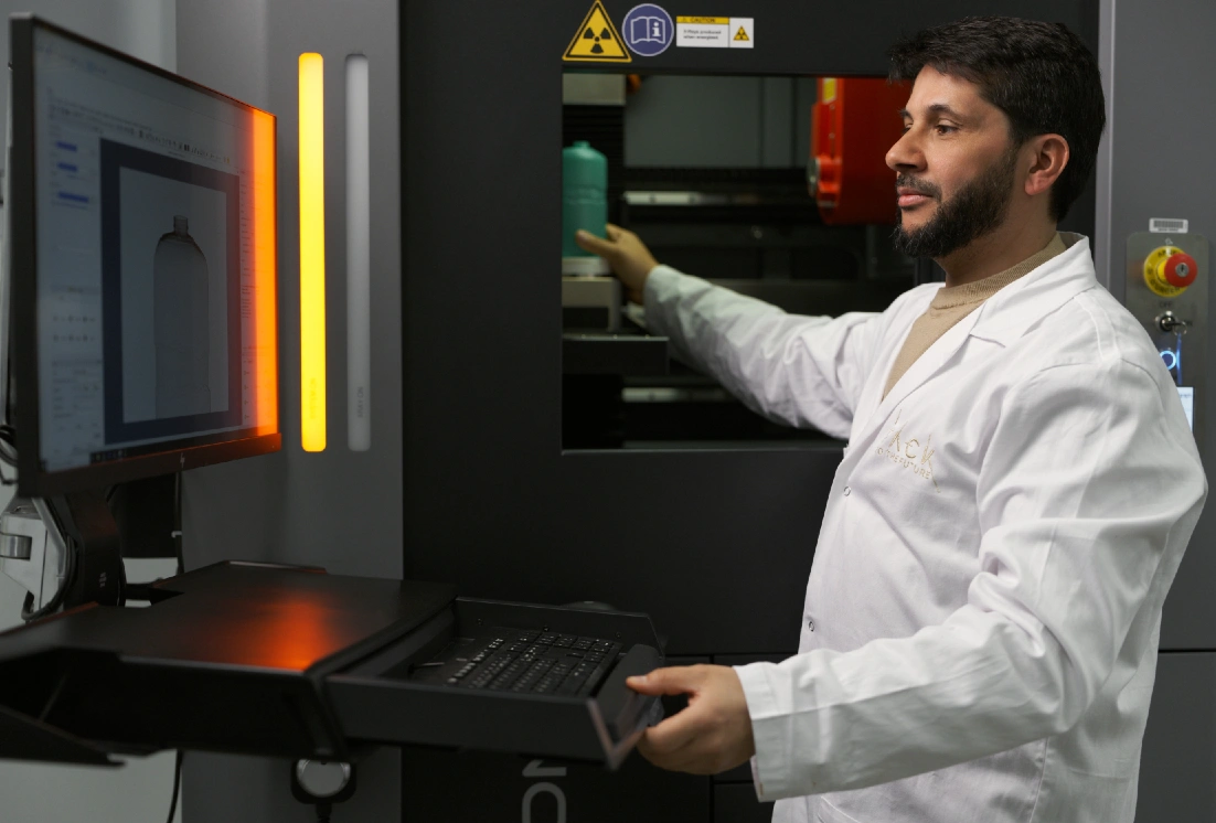 Technician using lab machine and screen