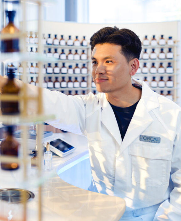 Lab worker reaching for bottles in research lab