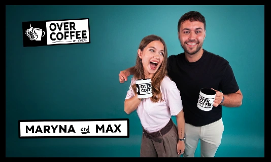 2 people posing and holding a coffee mug