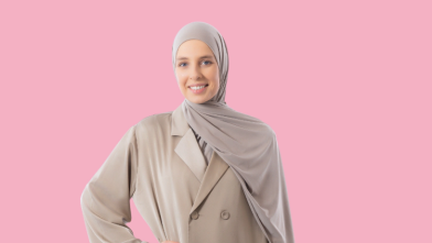 Persoon in beige outfit met hoofddoek