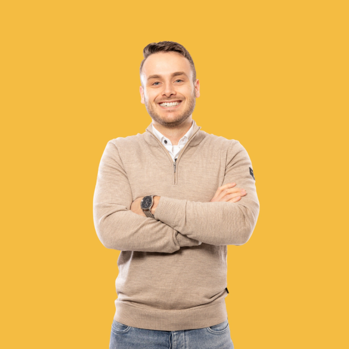 Person smiling with arms crossed