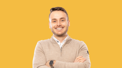 Person smiling with arms crossed