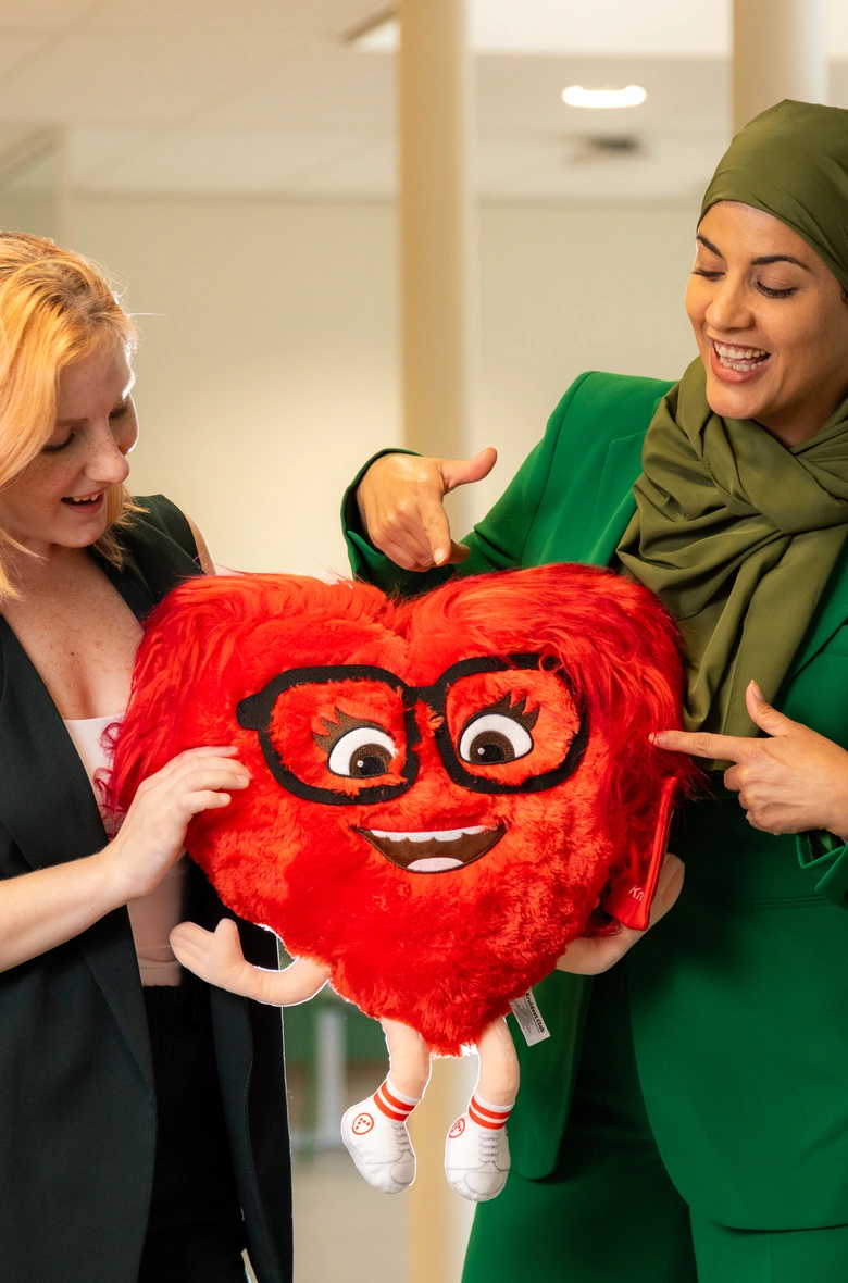 Women holding heart shaped toy