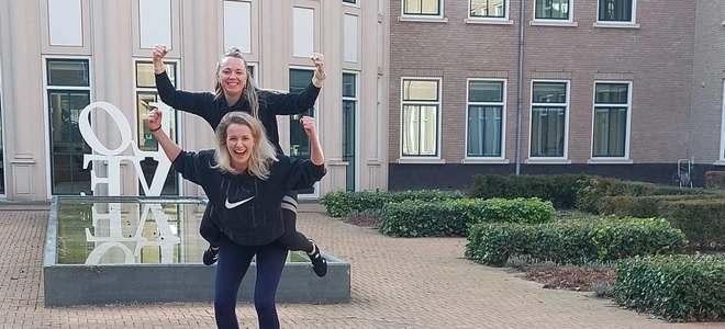 twee personen doen piggyback op binnenplaats