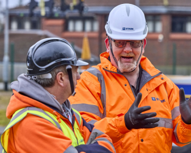 Construction team discuss worksite safety briefing