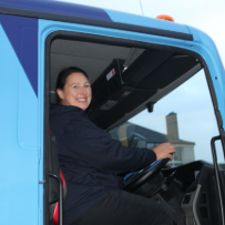 Driver seated in delivery truck cab ready for route