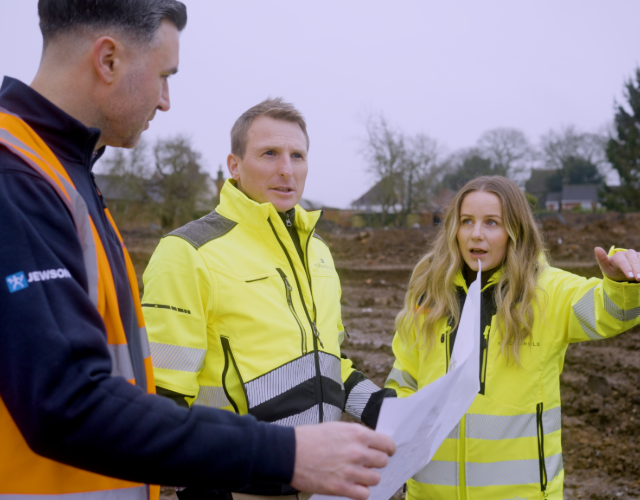 Site team in high-visibility jackets at worksite.