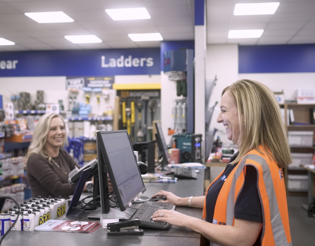 Customer served by staff member at trade counter