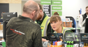 Store employee assisting customer at checkout