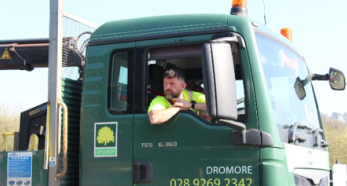 Person leaning from green truck cab