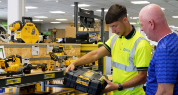 Store worker showing tool case to customer