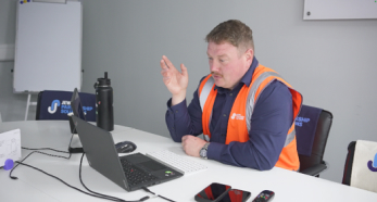 Person in high-visibility vest on video call