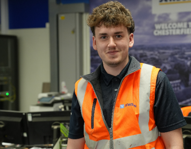 Team member in hi-vis vest inside branch workspace