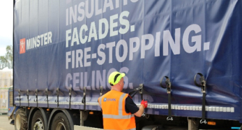 Person securing side curtain on Minster truck