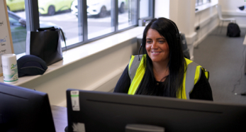 Person in hi-vis vest working at computer