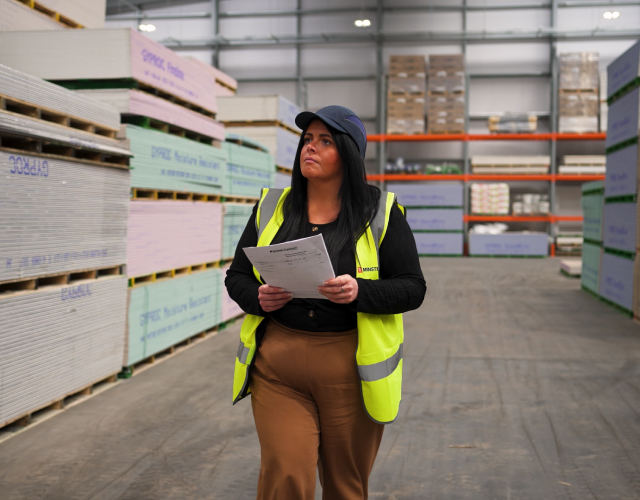 Woman in safety vest in warehouse