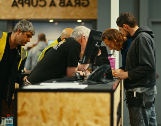 People checking in at event registration desk