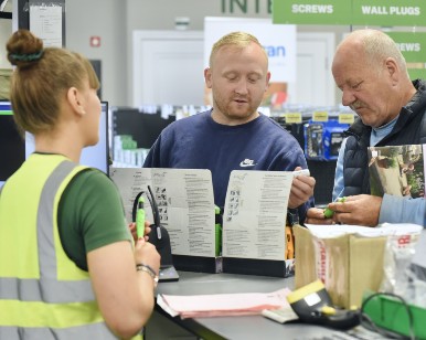 Workers in hi-vis vests inspect house build site