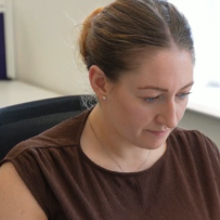 Office employee focused while working on computer