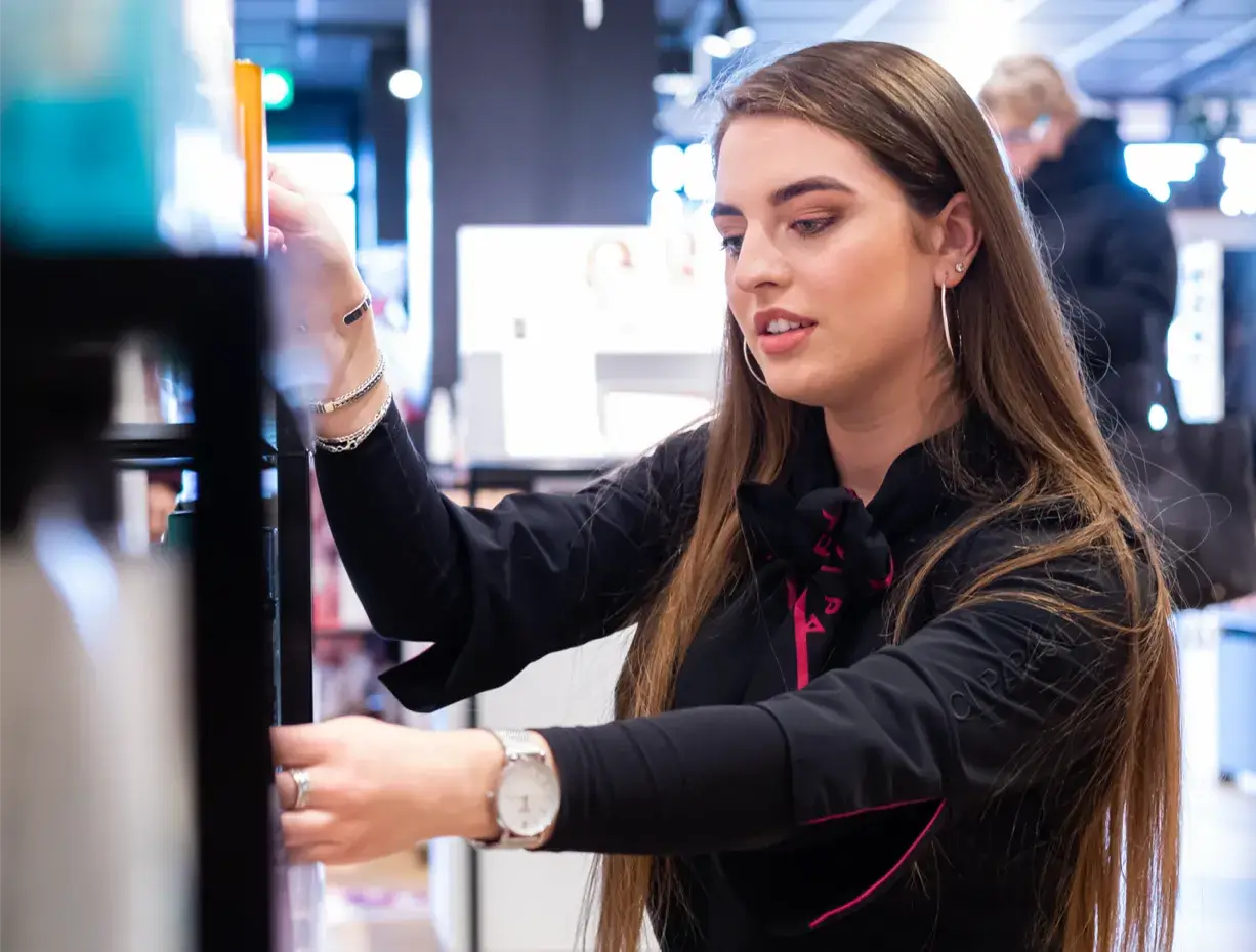 Woman arranging items in store